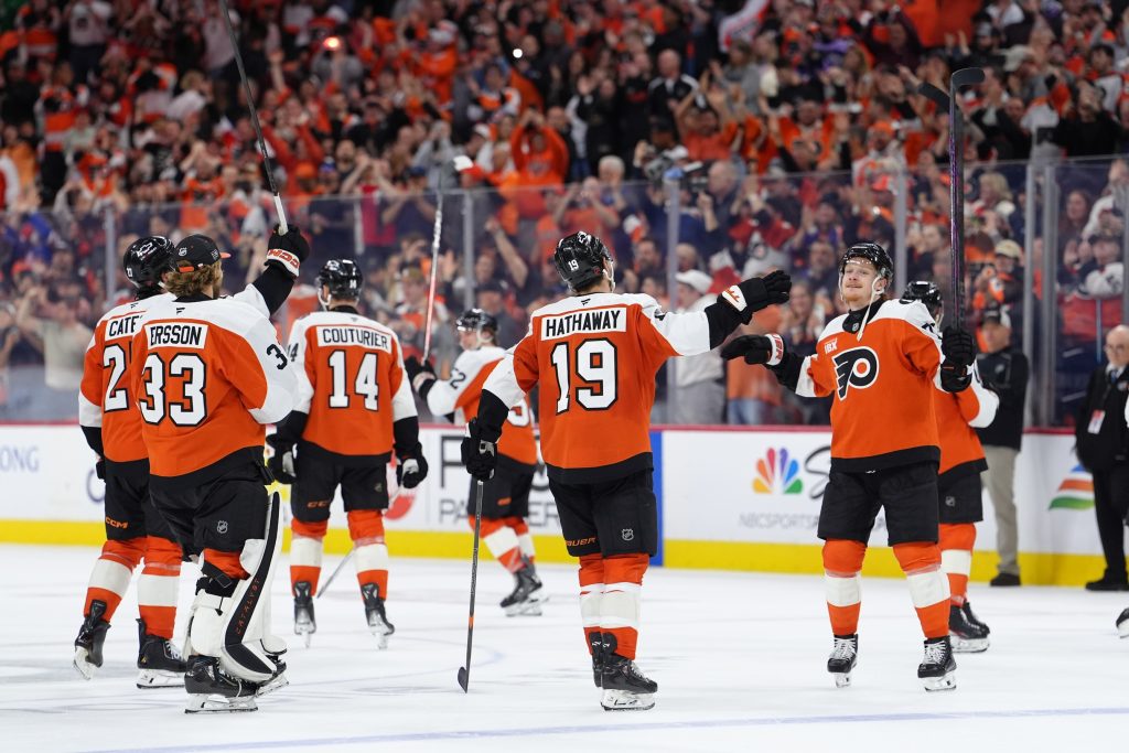 Apr 13, 2026; Philadelphia, Pennsylvania, USA; Philadelphia Flyers right wing Garnet Hathaway (19) and right wing Owen Tippett (74) celebrate with teammates after the game against the Carolina Hurricanes at Xfinity Mobile Arena.