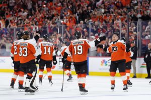Apr 13, 2026; Philadelphia, Pennsylvania, USA; Philadelphia Flyers right wing Garnet Hathaway (19) and right wing Owen Tippett (74) celebrate with teammates after the game against the Carolina Hurricanes at Xfinity Mobile Arena.