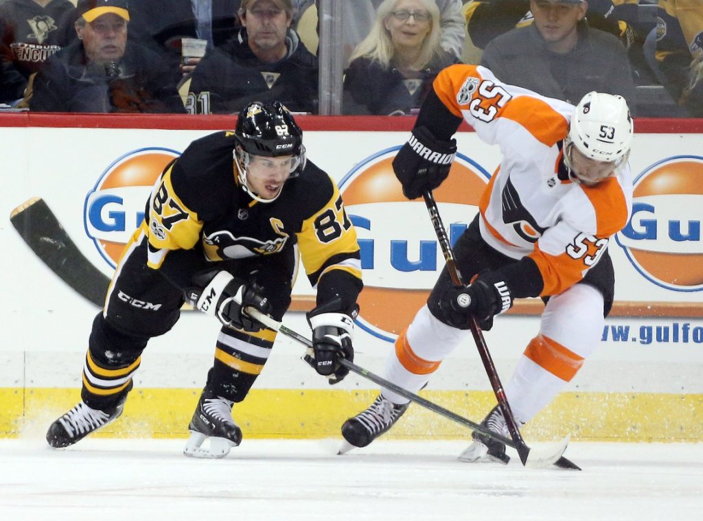 Nov 27, 2017; Pittsburgh, PA, USA; Pittsburgh Penguins center Sidney Crosby (87) and Philadelphia Flyers defenseman Shayne Gostisbehere (53) fight for the puck during the first period at PPG PAINTS Arena.