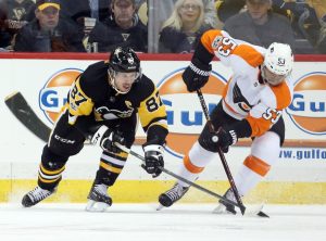 Nov 27, 2017; Pittsburgh, PA, USA; Pittsburgh Penguins center Sidney Crosby (87) and Philadelphia Flyers defenseman Shayne Gostisbehere (53) fight for the puck during the first period at PPG PAINTS Arena.