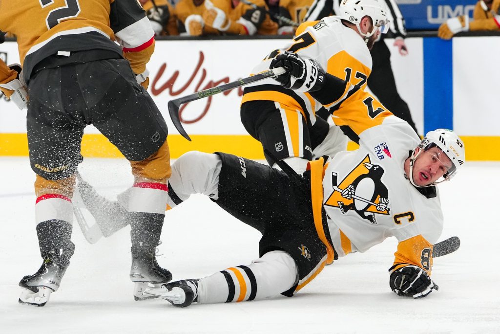 Mar 7, 2025; Las Vegas, Nevada, USA; Pittsburgh Penguins center Sidney Crosby (87) falls to the ice during the first period against the Vegas Golden Knights at T-Mobile Arena.