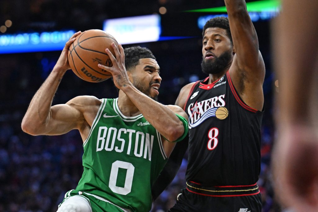 Apr 24, 2026; Philadelphia, Pennsylvania, USA; Boston Celtics forward Jayson Tatum (0) drives to the basket against Philadelphia 76ers forward Paul George (8) during the first half at Xfinity Mobile Arena.