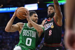 Apr 24, 2026; Philadelphia, Pennsylvania, USA; Boston Celtics forward Jayson Tatum (0) drives to the basket against Philadelphia 76ers forward Paul George (8) during the first half at Xfinity Mobile Arena.