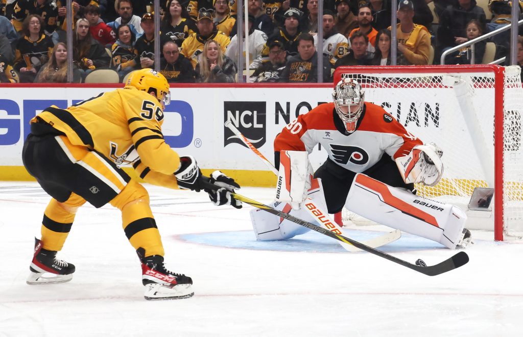 Apr 20, 2026; Pittsburgh, Pennsylvania, USA; Philadelphia Flyers goaltender Dan Vladar (80) defends the net against Pittsburgh Penguins right wing Egor Chinakhov (59) during the third period in game two of the first round of the 2026 Stanley Cup Playoffs at PPG Paints Arena.