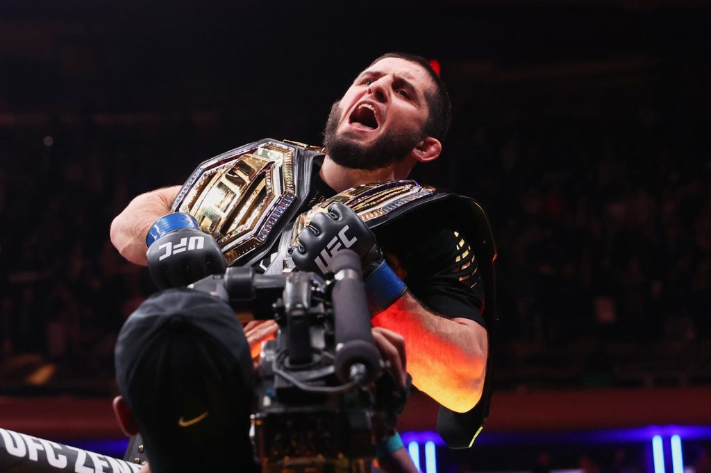 Nov 15, 2025; New York, NY, UNITED STATES; Islam Makhachev (blue gloves) celebrates after defeating Jack Della Maddalena (not pictured) by unanimous decision in the welterweight championship bout during UFC 322 at Madison Square Garden.