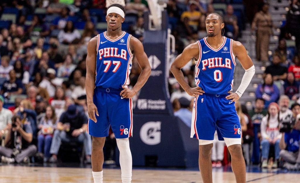 Feb 21, 2026; New Orleans, Louisiana, USA; Philadelphia 76ers guard Vj Edgecombe (77) and guard Tyrese Maxey (0) looks on against the New Orleans Pelicans during the first half at Smoothie King Center.