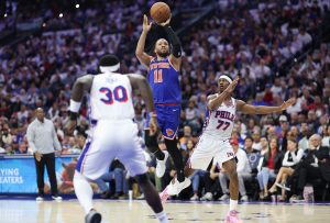May 8, 2026; Philadelphia, Pennsylvania, USA; New York Knicks guard Jalen Brunson (11) shoots in front of Philadelphia 76ers guard Vj Edgecombe (77) during the second quarter of game three of the second round of the 2026 NBA Playoffs at Xfinity Mobile Arena.