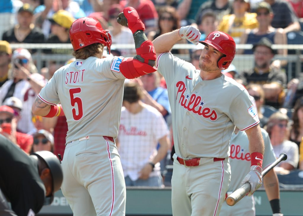 May 17, 2026; Pittsburgh, Pennsylvania, USA; Philadelphia Phillies catcher J.T. Realmuto (right) greets second baseman Bryson Stott (5) crossing home plate on a solo home run against the Pittsburgh Pirates during the eighth inning at PNC Park.