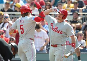 May 17, 2026; Pittsburgh, Pennsylvania, USA; Philadelphia Phillies catcher J.T. Realmuto (right) greets second baseman Bryson Stott (5) crossing home plate on a solo home run against the Pittsburgh Pirates during the eighth inning at PNC Park.