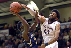 Feb 13, 2016; Philadelphia, PA, USA; Saint Joseph's Hawks forward DeAndre Bembry (43) defends against La Salle Explorers guard Cleon Roberts (3) during the first half at Michael J. Hagan Arena.
