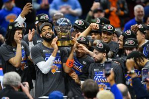 May 25, 2026; Cleveland, Ohio, USA; New York Knicks center Karl-Anthony Towns (32) lifts the 2026 Eastern Conference trophy with teammates after defeating the Cleveland Cavaliers in game four of the eastern conference finals for the 2026 NBA playoffs at Rocket Arena.
