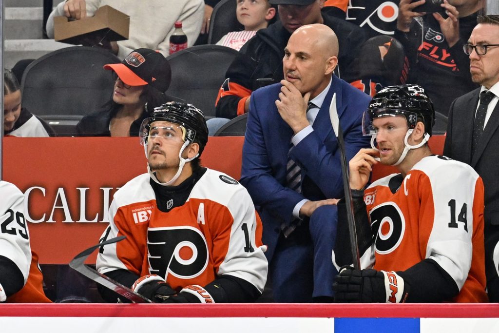 Oct 13, 2025; Philadelphia, Pennsylvania, USA; Philadelphia Flyers head coach Rick Tocchet with right wing Travis Konecny (11) and center Sean Couturier (14) against the Florida Panthers during the first period at Wells Fargo Center. :