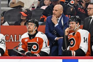 Oct 13, 2025; Philadelphia, Pennsylvania, USA; Philadelphia Flyers head coach Rick Tocchet with right wing Travis Konecny (11) and center Sean Couturier (14) against the Florida Panthers during the first period at Wells Fargo Center. :