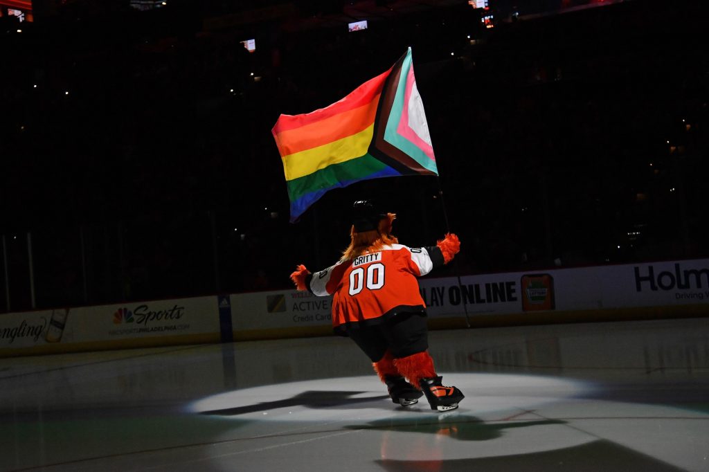 Jan 10, 2024; Philadelphia, Pennsylvania, USA; Philadelphia Flyers mascot Gritty carries a flag in support of LGBTQ+ community during annual Pride Game against the Montreal Canadiens at Wells Fargo Center.