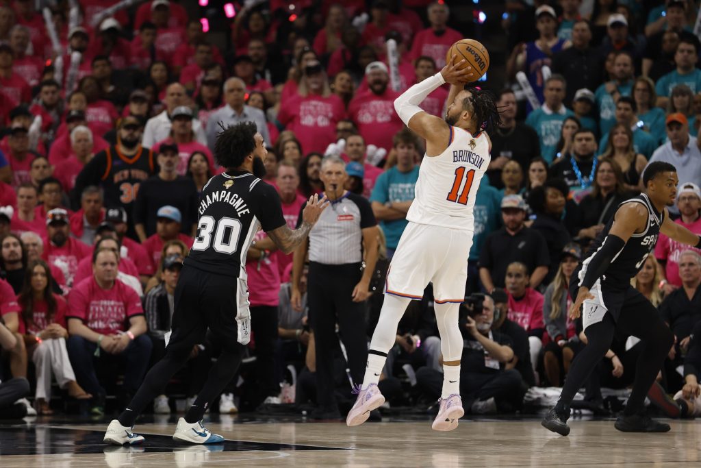 Jun 3, 2026; San Antonio, Texas, USA; New York Knicks guard Jalen Brunson (11) shoots the ball past San Antonio Spurs forward Julian Champagnie (30) in the second half during game one of the 2026 NBA Finals at Frost Bank Center.