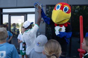 University of Kansas mascot Big Jay high fives Qatar native Amin Al after answering a question right during the Algeria community training session ahead of their World Cup match at Rock Chalk Park on June 11, 2026.