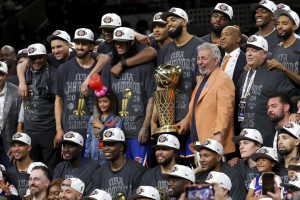 Jun 13, 2026; San Antonio, Texas, USA; New York Knicks owner James Dolan and the Knicks pose with the trophy after the Knicks defeat the San Antonio Spurs during game five of the 2026 NBA Finals at Frost Bank Center.