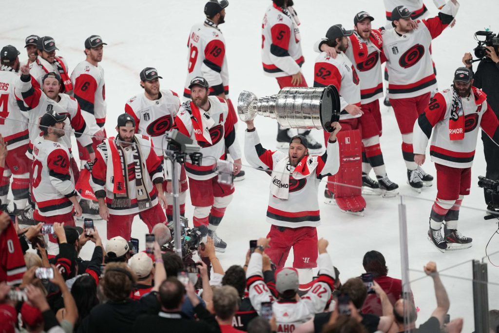 Jun 14, 2026; Las Vegas, Nevada, USA; Carolina Hurricanes celebrate with the Stanley Cup after defeating Vegas Golden Knights in game six of the 2026 Stanley Cup Final at T-Mobile Arena.