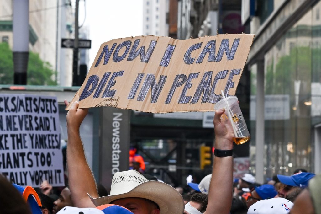 Jun 18, 2026; New York, NY, USA; A parade goer holds up a sign along the parade route on Canyon of Heroes for the New York Knicks Championship Parade.