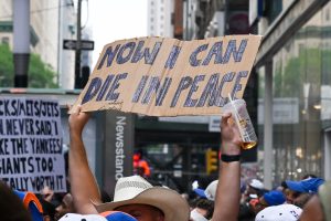 Jun 18, 2026; New York, NY, USA; A parade goer holds up a sign along the parade route on Canyon of Heroes for the New York Knicks Championship Parade.