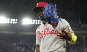 Jun 9, 2026; Toronto, Ontario, CAN; Philadelphia Phillies right fielder Adolis Garcia (53) tosses his glove in the air as he returns to the dug out against the Toronto Blue Jays at Rogers Centre.
