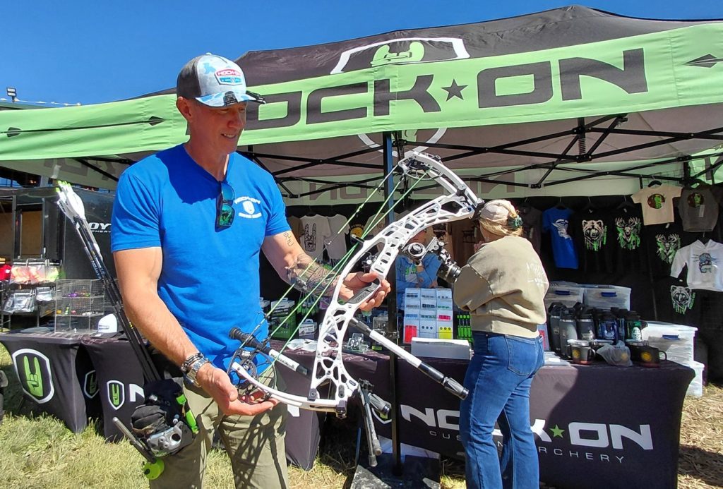 John Dudley of Nock On Archery looks over his bow May 28, 2026, at the Total Archery Challenge at Seven Springs. He enjoys helping archers learn to shoot longer distances like those found on these 3D animal courses.