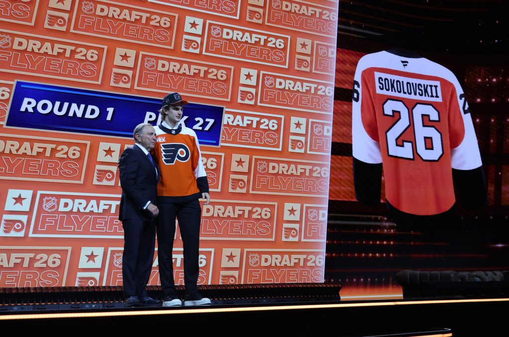 Jun 26, 2026; Buffalo, New York, USA; Maksim Sokolovskii reacts beside NHL commissioner Gary Bettman after being selected with the twenty seventh pick in the first round of the 2026 NHL Draft by the Philadelphia Flyers at KeyBank Center.