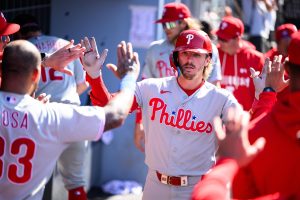 May 31, 2026; Los Angeles, California, USA; Philadelphia Phillies second baseman Bryson Stott (5) is greeted by teammates after hitting a home run during the ninth inning against the Los Angeles Dodgers at Dodger Stadium.