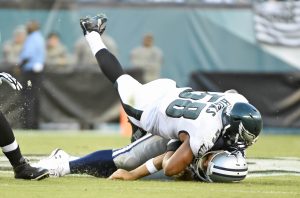 Sep 20, 2015; Philadelphia, PA, USA; Philadelphia Eagles outside linebacker Jordan Hicks (58) lands on Dallas Cowboys quarterback Tony Romo (9) during the third quarter at Lincoln Financial Field. Romo was injured on the play and left the game. The Cowboys defeated the Eagles, 20-10. Mandatory Credit: Eric Hartline-USA TODAY Sports