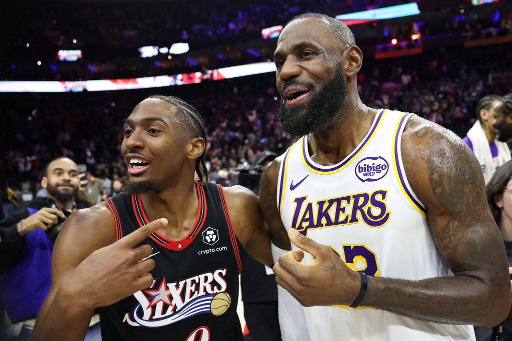 Dec 7, 2025; Philadelphia, Pennsylvania, USA; Los Angeles Lakers forward Lebron James (23) and Philadelphia 76ers guard Tyrese Maxey react with each other after the game at Xfinity Mobile Arena.