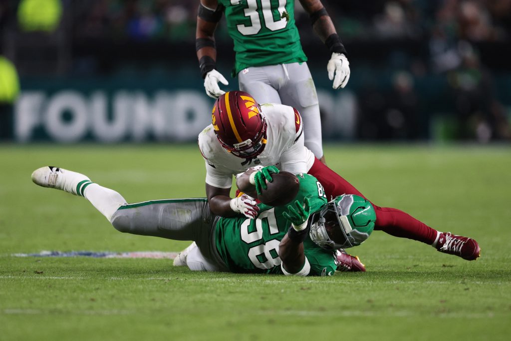 Jan 4, 2026; Philadelphia, Pennsylvania, USA; Philadelphia Eagles linebacker Jalyx Hunt (58) intercepts a pass intended for Washington Commanders wide receiver Deebo Samuel (1) during the second quarter at Lincoln Financial Field.
