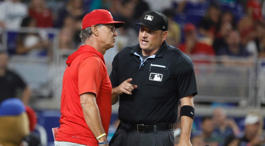 Jul 27, 2026; Miami, Florida, USA; Philadelphia Phillies interim manager Don Mattingly (8) speaks with home plate umpire Dan Bellino against the Miami Marlins during the sixth inning at loanDepot Park.