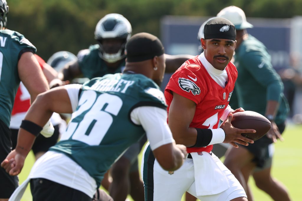 Jul 29, 2026; Philadelphia, PA, USA; Philadelphia Eagles quarterback Jalen Hurts (1) hands off to running back Saquon Barkley (26) during training camp at Jefferson Health Training Complex.