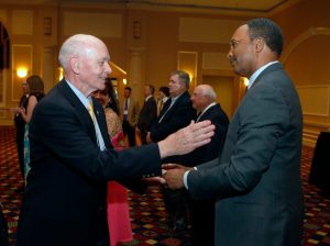 Delaware Sports Hall of Fame inductee Bob Neylan (Dover High track and track coach) greets former team member Ukee Washington during the 40th annual Delaware Sports Museum and Hall of Fame banquet at the Chase Center on the Riverfront, where 10 people were inducted into the hall in 2015.