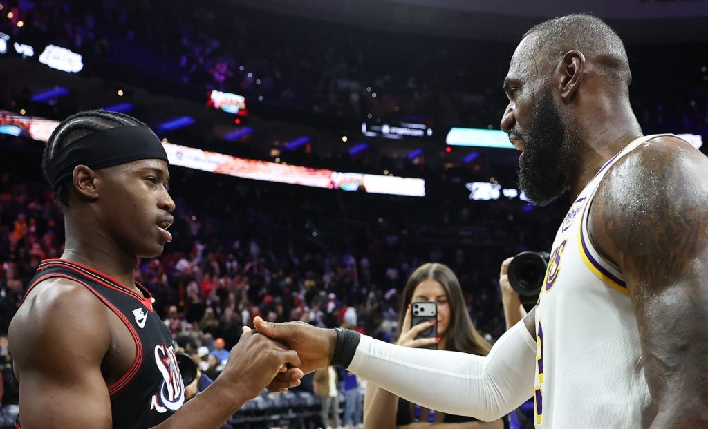 Dec 7, 2025; Philadelphia, Pennsylvania, USA; Los Angeles Lakers forward Lebron James (23) shakes hands with Philadelphia 76ers guard Vj Edgecombe (77) after the game at Xfinity Mobile Arena.