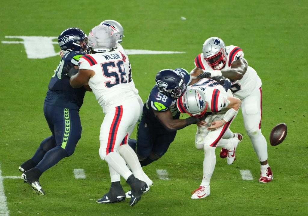 Feb 8, 2026; Santa Clara, CA, USA; New England Patriots quarterback Drake Maye (10) fumbles as he is sacked by Seattle Seahawks linebacker Derick Hall (58) in the second half in Super Bowl LX at Levi's Stadium.