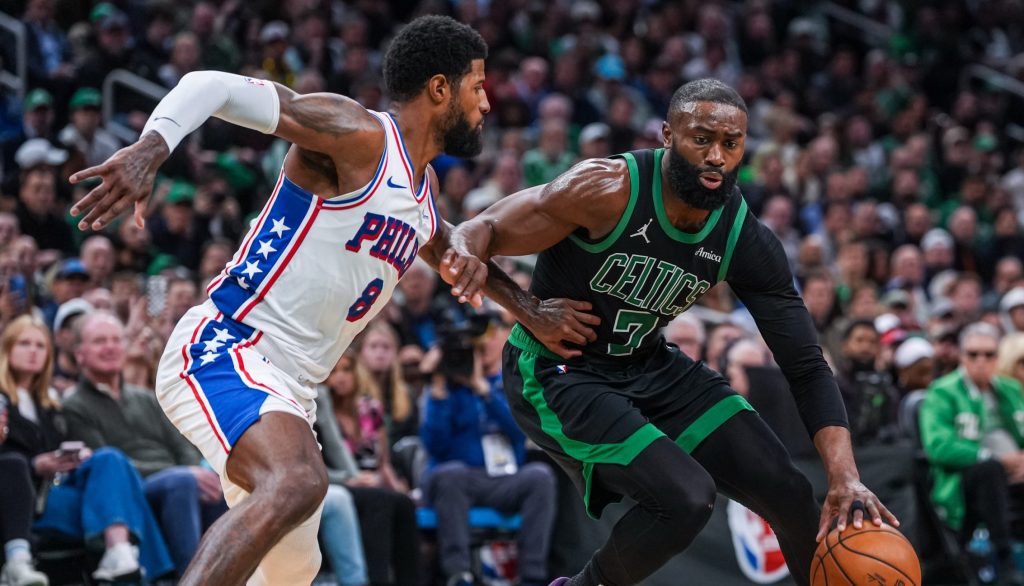 Apr 28, 2026; Boston, Massachusetts, USA; Boston Celtics guard Jaylen Brown (7) drives the ball against Philadelphia 76ers forward Paul George (8) in the second half during game five of the first round of the 2026 NBA Playoffs at TD Garden.