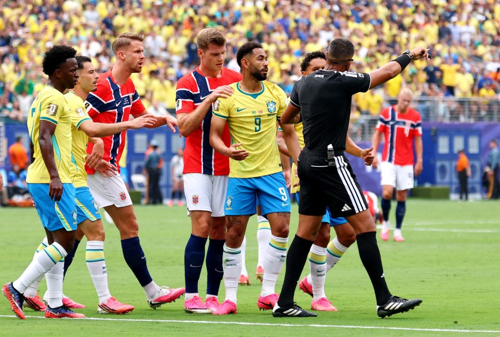 July 5, 2026; East Rutherford, New Jersey, U.S.; Brazil's Matheus Cunha remonstrates with referee Ismail Elfath after Norway's Kristoffer Ajer fouls him to concede a penalty after VAR review.