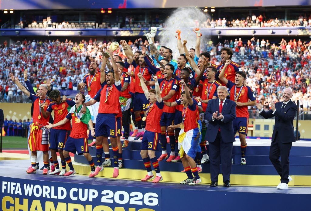 July 19, 2026; East Rutherford, New Jersey, U.S.; U.S. President Donald Trump and FIFA President Gianni Infantino are seen as Spain players celebrate with the trophy after winning the World Cup.