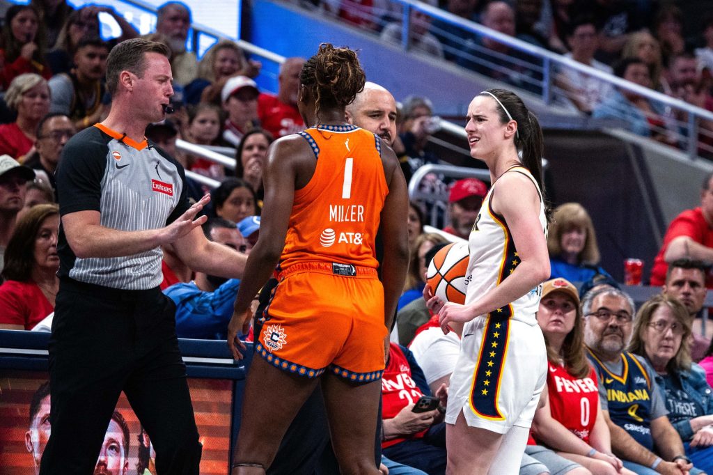 Jul 22, 2026; Indianapolis, Indiana, USA; Connecticut Sun forward Diamond Miller (1) gets a technical foul for after whistle contact on Indiana Fever guard Caitlin Clark (22) in the second half at Gainbridge Fieldhouse.