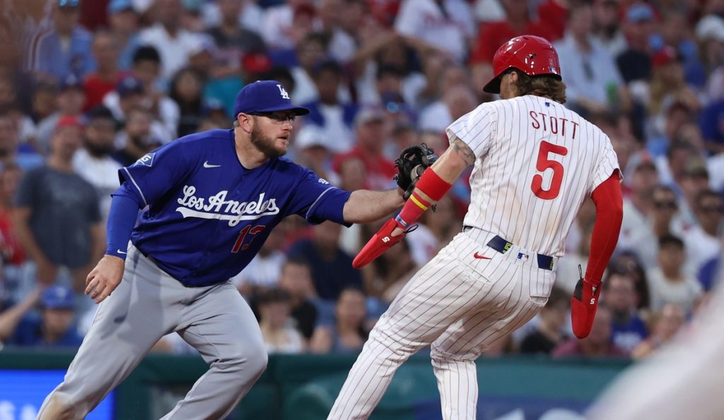 Jul 22, 2026; Philadelphia, Pennsylvania, USA; Los Angeles Dodgers third baseman Max Muncy (13) tags out Philadelphia Phillies second baseman Bryson Stott (5) during the fifth inning at Citizens Bank Park.