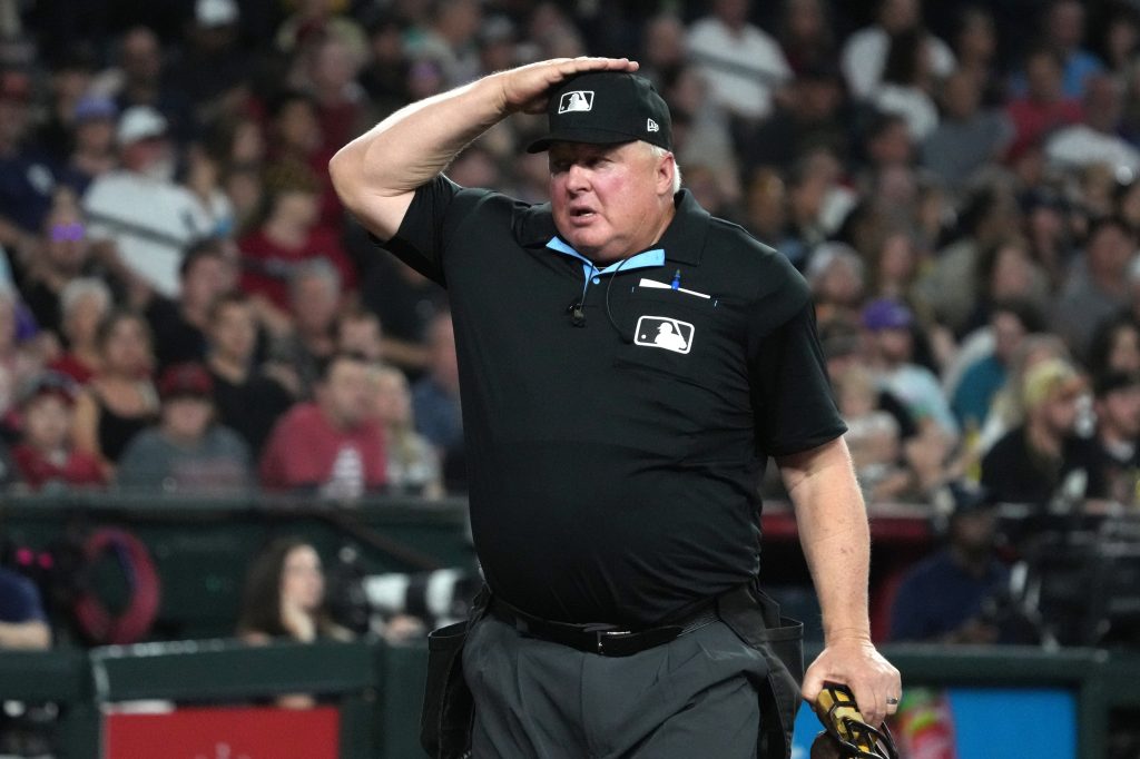 Mar 31, 2026; Phoenix, Arizona, USA; MLB umpire Bill Miller (26) signals for a pitch challenge for the Arizona Diamondbacks against the Detroit Tigers in the third inning at Chase Field.