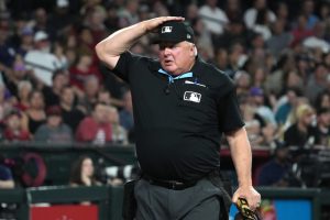 Mar 31, 2026; Phoenix, Arizona, USA; MLB umpire Bill Miller (26) signals for a pitch challenge for the Arizona Diamondbacks against the Detroit Tigers in the third inning at Chase Field.