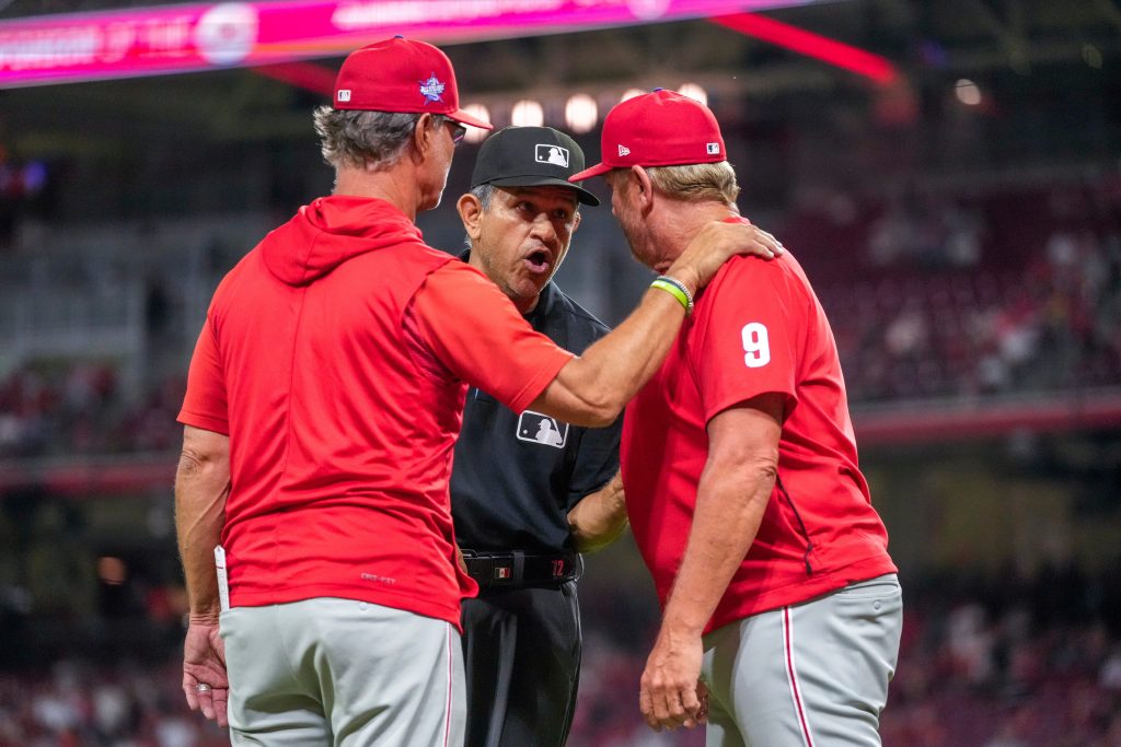 Philadelphia Phillies infield coach Bobby Dickerson (9) rushes from the dugout to argue a call with crew chief umpire Alfonso Márquez (72) in the eighth inning of the MLB National League game between the Cincinnati Reds and the Philadelphia Phillies at Great American Ball Park in downtown Cincinnati on Tuesday, July 7, 2026. The Reds lost 4-1 to the Phillies.