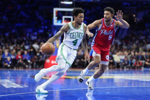 Oct 31, 2025; Philadelphia, Pennsylvania, USA; Boston Celtics guard Anfernee Simons (4) drives against Philadelphia 76ers guard Quentin Grimes (5) in the second quarter at Xfinity Mobile Arena. K