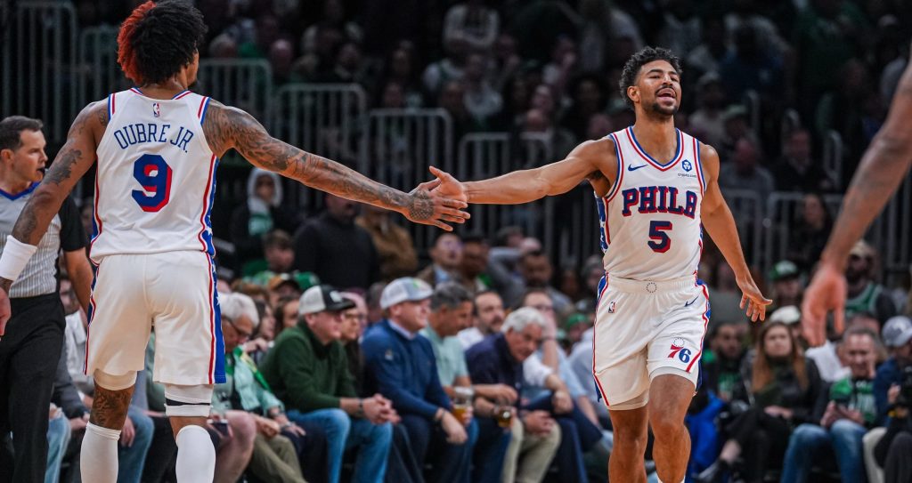 Apr 28, 2026; Boston, Massachusetts, USA; Philadelphia 76ers guard Quentin Grimes (5) and guard Kelly Oubre Jr. (9) react after a play against the Boston Celtics in the second half during game five of the first round of the 2026 NBA Playoffs at TD Garden.