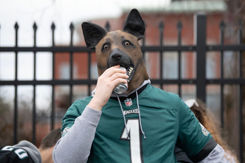 Luke Godzieba of Delaware County chugs a can of beer with a dog, or what he calls an "underdog," mask at a parking lot near Lincoln Financial Field in Philadelphia before Eagles' NFL conference championship game against 49ers on Sunday, Jan. 29, 2023. Eaglestailgating17