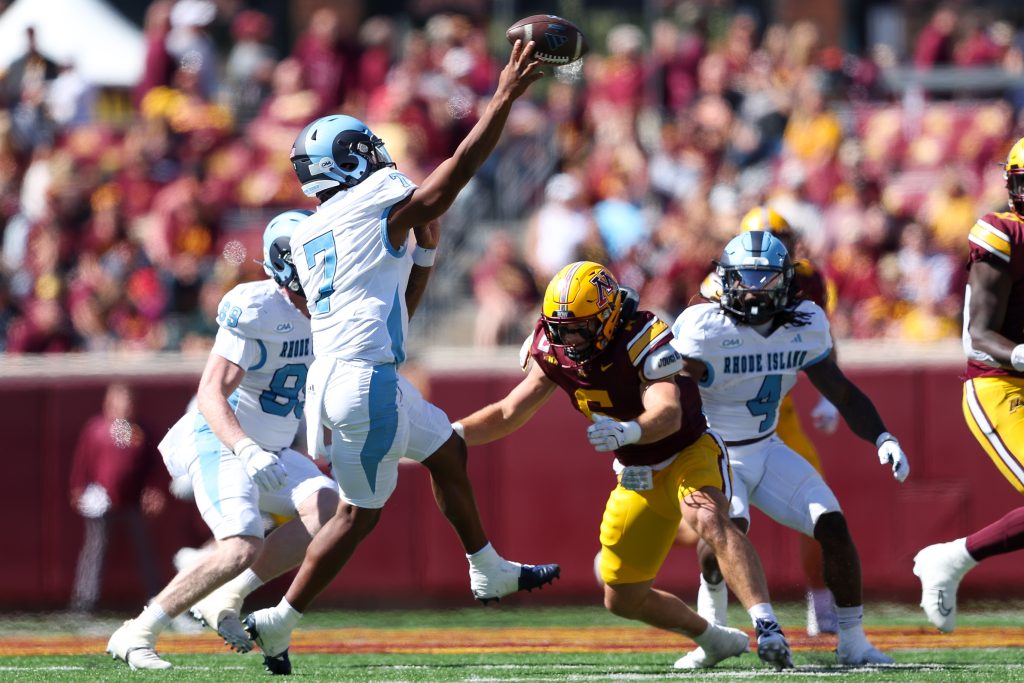 Sep 7, 2024; Minneapolis, Minnesota, USA; Rhode Island Rams quarterback Devin Farrell (7) throws the ball as Minnesota Golden Gophers linebacker Maverick Baranowski (6) defends during the first half at Huntington Bank Stadium.