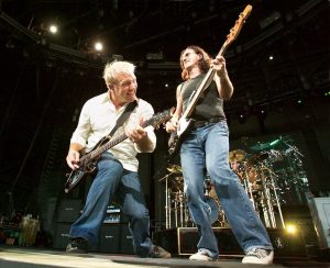 Guitarist Alex Lifeson ,left and bassist Geddy Lee ,right along with drummer Neil Peart play a medley of songs on their 30 anniversary tour stop at the Ford Amphitheatre in Tampa, Fl. Friday July 30 ,2004.The Canadian power rock trio recently released a Cd with cover tunes of hits like The Seeker by The Who and Crossroads, a Robert Johnson song popularized by Eric Clapton in his Cream days .
