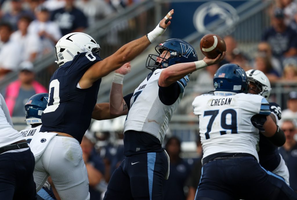 Sep 13, 2025; University Park, Pennsylvania, USA; Villanova Wildcats quarterback Pat McQuaide (7) throws the ball while being pressured by Penn State Nittany Lions linebacker Dominic DeLuca (0) during the third quarter at Beaver Stadium.